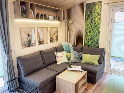 a living room with a couch and a table at Holiday Home Tiny Haus Tiny Moments by Interhome in Wemding