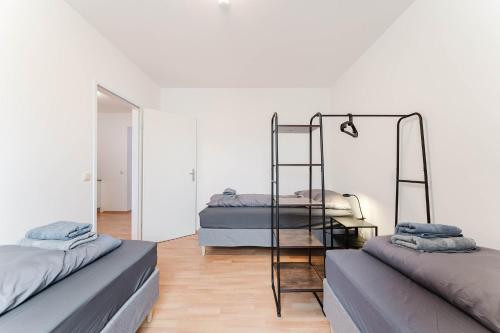 a bedroom with two bunk beds and a mirror at feworld living - Linzer Wasserwald in Linz