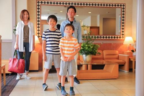 a group of people standing in a living room at Hotel Meijiya in Hamamatsu