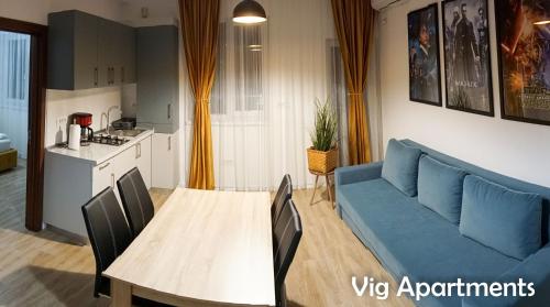 a living room with a blue couch and a table at Vig Apartments in Timişoara