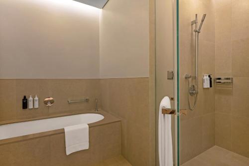 a bathroom with a bath tub and a shower at Vida Dubai Mall in Dubai