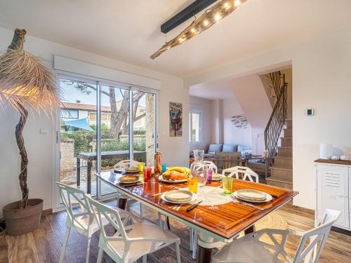 a dining room with a table and chairs at Holiday Home Le Rayolet Parc by Interhome in Six-Fours-les-Plages