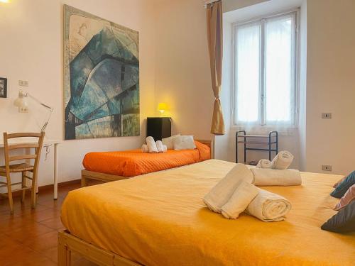 a bedroom with two beds and a painting on the wall at LOVELYLOFT, via Meda in Milan