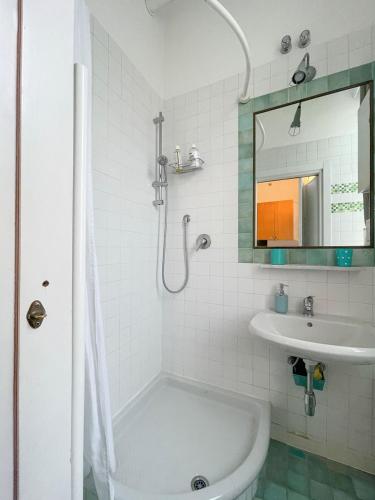 a white bathroom with a tub and a sink at LOVELYLOFT, via Meda in Milan