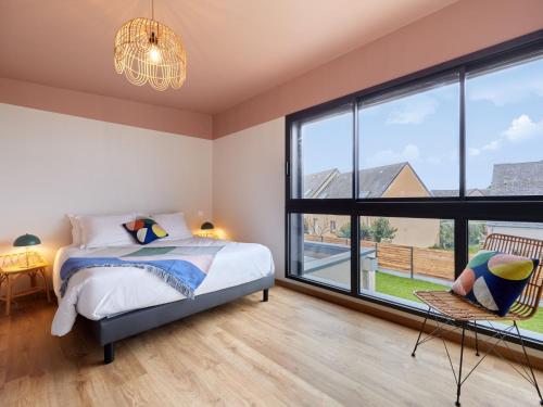 a bedroom with a bed and a large window at Holiday Home L'Aventure Gouvillaise by Interhome in Gouville-sur-Mer