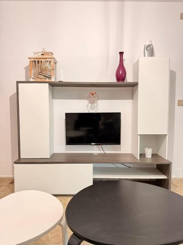 a living room with a table and a fireplace at Apartamentos Portolux in Portomarin