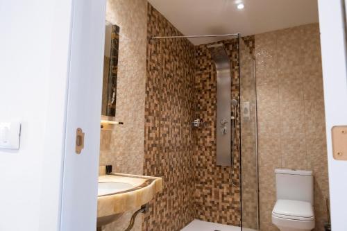 a bathroom with a sink and a toilet and a shower at Mandarina 119 in San Miguel de Abona