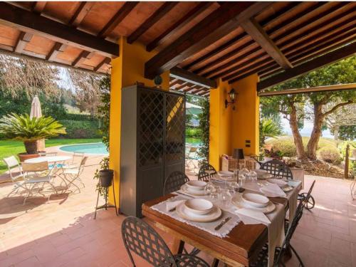 a dining table and chairs on a patio at Holiday Home Villa Silvana by Interhome in Marcialla