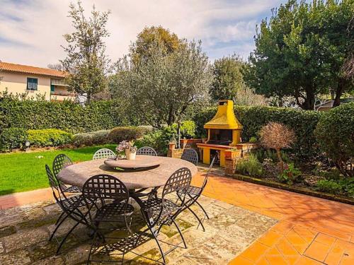 a patio with a table and chairs and a fire place at Holiday Home Villa Silvana by Interhome in Marcialla