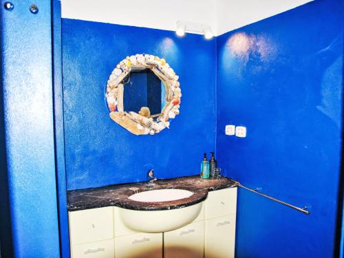 a blue bathroom with a sink and a mirror at Villa Giulia by Interhome in Sperlonga