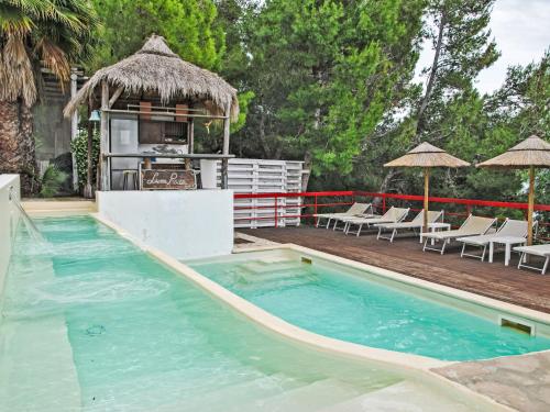 a swimming pool with a kitchen and lounge chairs at Villa Giulia by Interhome in Sperlonga