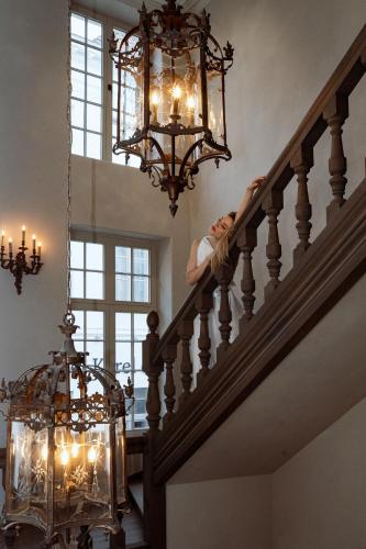 a man laying on the stairs of a house at The Notary in Bruges