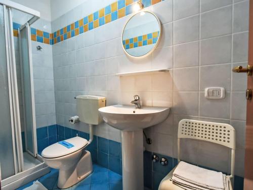 a bathroom with a sink and a toilet and a mirror at Apartment Solmare-52 by Interhome in Rosapineta