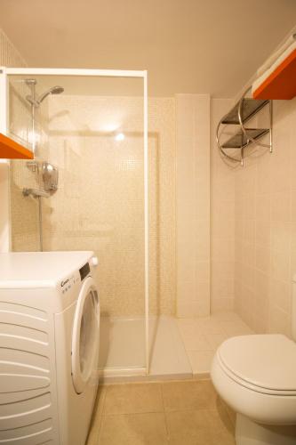a white bathroom with a shower and a toilet at Rincón de Tramacastilla de Tena in Tramacastilla de Tena