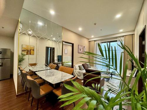 a dining room with a table and some plants at Căn Hộ 2 Phòng Ngủ LUXURY 2502 in Gia Lâm Pho