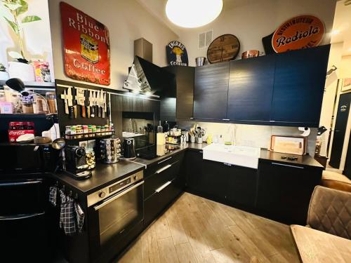 une cuisine avec des armoires noires et un comptoir dans l'établissement Perfect Home to discover Paris in Peace with Love, à Paris