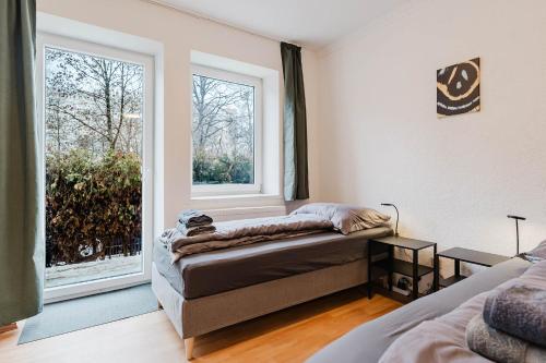 a living room with a couch and a window at feworld living - Wasserwald Linz in Linz