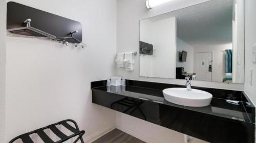 a bathroom with a sink and a mirror at Motel 6-Metropolis, IL in Metropolis