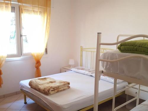 a bedroom with two bunk beds and a window at Berta in Rosolina