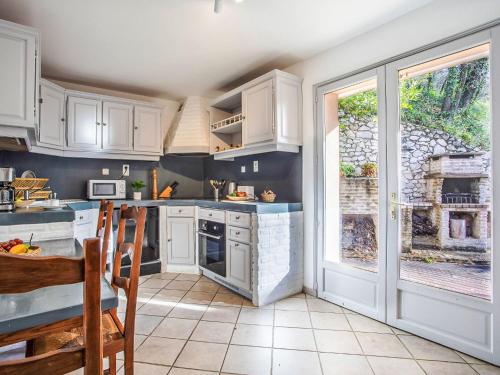 a kitchen with white cabinets and a large window at Villa Villa Bellevue by Interhome in Saint Paul de Vence