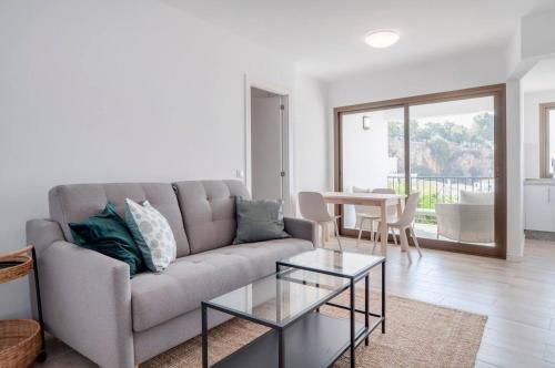 a living room with a couch and a table at New Apartment With Stunning Views in Mijas
