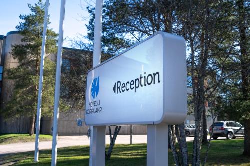 a sign for a presentation in front of a building at Hotel Korpilampi in Espoo