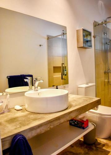 a bathroom with a sink and a toilet at Cottage for Couples with Pool, BBQ and views in Tamarin