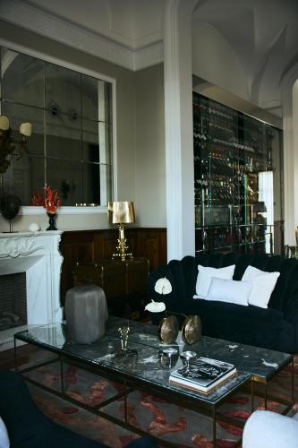 a living room with a black couch and a table at Palazzo del Corso – Boutique Hotel in Gallipoli