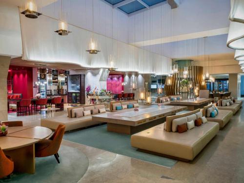 a lobby with couches and tables and a restaurant at Novotel Istanbul Bosphorus Hotel in Istanbul