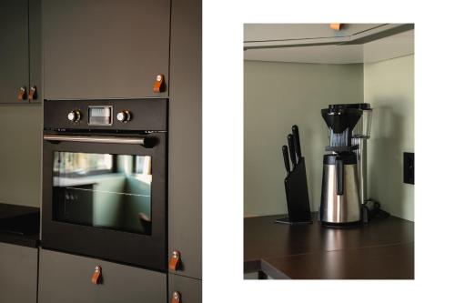 a kitchen with a black oven and a blender at Odda Trolltunga Atmosphere in Odda