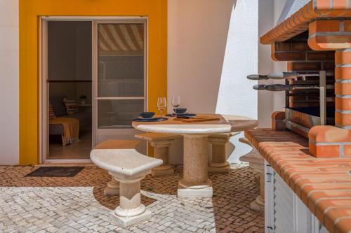 a patio with a table and wine glasses at TAC - Serenity Manta Rota in Vila Nova De Cacela