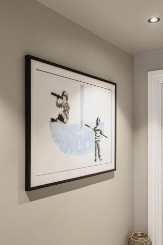 a framed picture of two people on a wall at Odda Trolltunga Atmosphere in Odda