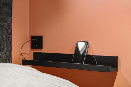 a drawer with a phone in it next to a bed at Odda Trolltunga Atmosphere in Odda