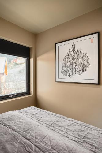 a bedroom with a drawing on the wall next to a bed at Odda Trolltunga Atmosphere in Odda