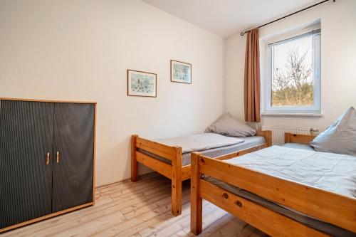 a bedroom with two beds and a window at Kolbatzer Mühle in Lychen