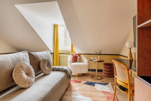 a living room with a couch and a table at Colette - LoftAffair Collection in Warsaw
