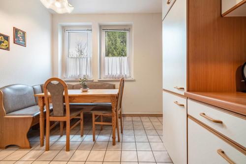 a kitchen and dining room with a table and chairs at Kolbatzer Mühle in Lychen