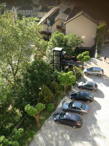 a group of cars parked in a parking lot at Golf Hôtel in Brides-les-Bains