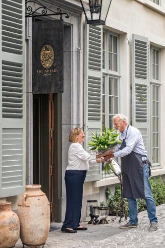 a man and a woman holding a basket of flowers at The Notary in Bruges