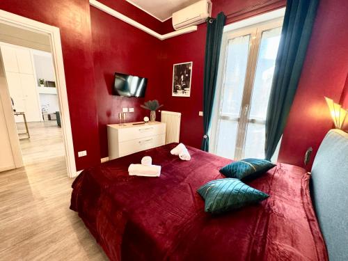 a red bedroom with a large red bed with pillows at Milano Duomo Design Apartment in Milan
