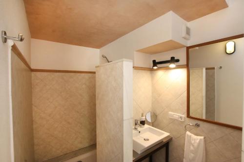 a bathroom with a sink and a mirror at Ca Na Barbara in Santanyi