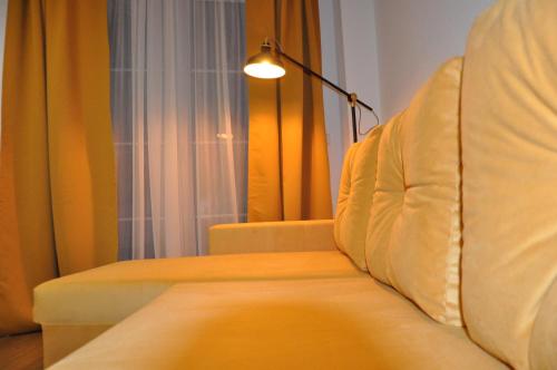 a living room with a couch and a lamp at Komfortables Apartment in Mainz in Mainz