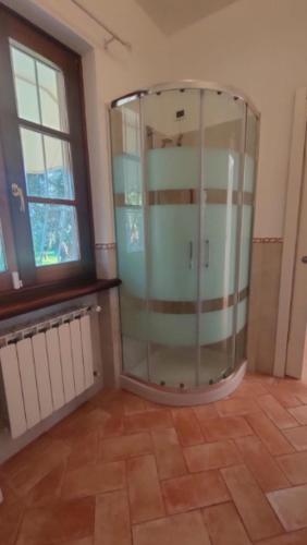 a glass shower in a room with a window at VILLA BICE in Versilia - Piscina Privata - Toscana in Pietrasanta