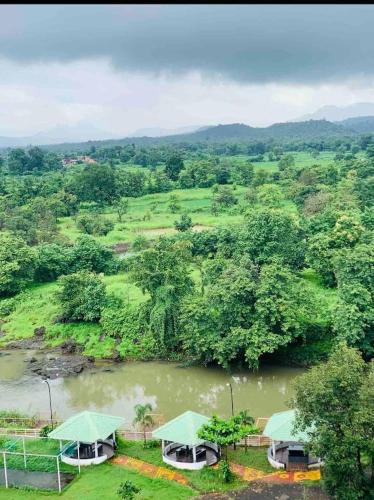 an aerial view of a river with two boats in it at Ivy Pali Studio Room with Common Pool 12 kms from Imagicaa in Jambhulpāda