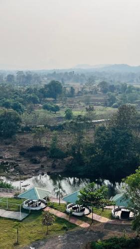 a view of a river with buildings and a waterfall at Ivy Pali Studio Room with Common Pool 12 kms from Imagicaa in Jambhulpāda