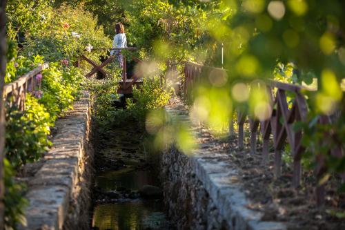 a person standing on a bridge over a river at Casas Novas Countryside Hotel Spa & Events in Chaves