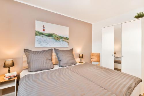 a bedroom with a bed and a lighthouse at Inselblick Klausdorf - Entspannung an der Küste in Klausdorf Mecklenburg Vorpommern