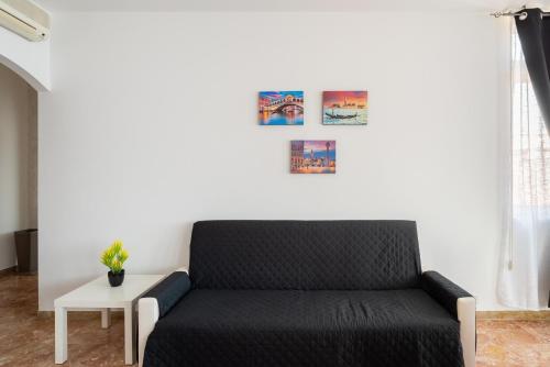 a black couch in a living room with a table at Like At Home Venice - Mestre in Mestre