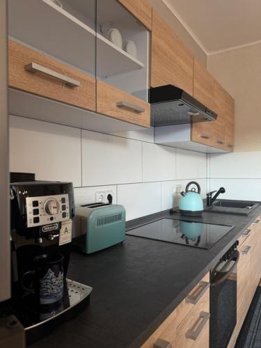 a kitchen with a blue tea kettle on a counter at Ferienwohnung-Anna in Fischbach bei Dahn
