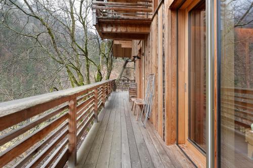 a wooden walkway on a house with a balcony at Laugen Lodge in San Pancrazio dʼUltimo